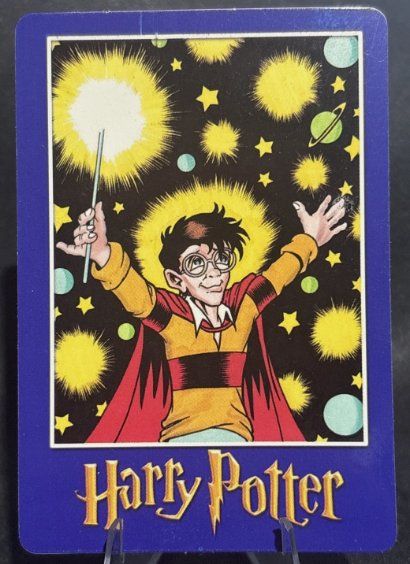 Harry Potter “Magic Will Happen” vending card: Harry with arms outstretched and a glowing wand among stars and planets